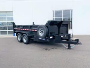 profile of dual ram dump trailer in down position in front of building