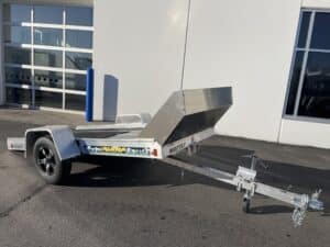 front 3/4 view up of Tilt Bed Snowmobile Trailer tilted down to act as a ramp